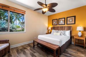 a bedroom with a bed and a ceiling fan at Kulalani at Mauna Lani 205 in Waikoloa +46 photos