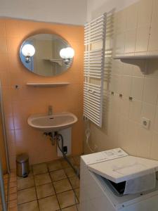 a bathroom with a sink and a mirror at HaK-3 in Wittdün