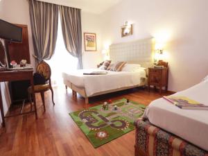 a hotel room with two beds and a desk at Hotel Sant'Angelo in Rome