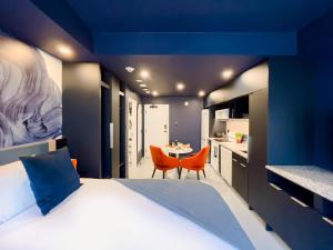 a bedroom with a large bed and a dining room at Pierce Boutique Apartments by Simplissimmo in Montréal