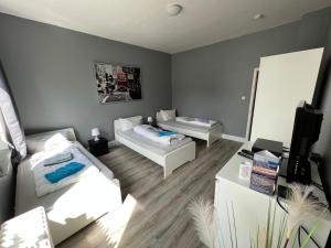 a living room with two couches and a tv at Stadtnah an der Förde 7 1OG R in Flensburg