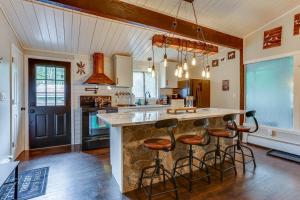 a kitchen with a large counter with stools around it at East Stroudsburg Home Near Skiing and Del Water Gap! in East Stroudsburg