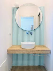a bathroom with a sink and a mirror at Le Conchiglie Residence in Porto Torres