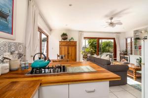 a kitchen with a stove top oven next to a living room at Founders Keepers - Leisure Isle in Knysna