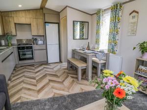 a kitchen with a wooden floor and a table at Jean's Place in Ganton