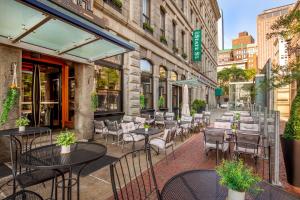 an outdoor patio with tables and chairs on a city street at Harborside Inn in Boston