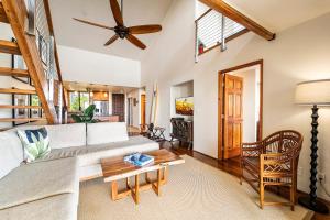 a living room with a couch and a ceiling fan at Country Club Villas 338 in Kailua-Kona