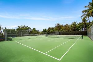 a tennis court with two tennis nets on it at Country Club Villas 338 in Kailua-Kona
