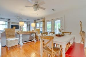 a kitchen and dining room with a table and chairs at Pensacola Paradise Furnished Deck and Gas Grill! in Pensacola