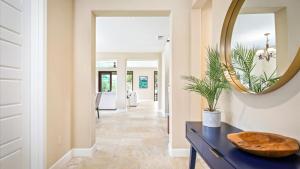 a hallway of a home with a mirror on the wall at Holua Kai 2 in Kailua-Kona