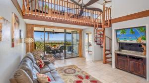 a living room with a couch and a tv at Country Club Villas 341 in Kailua-Kona