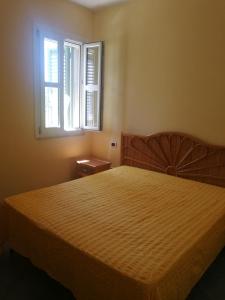 a bedroom with a large bed and a window at Il Rifugio Gallipoli Baia verde in Gallipoli