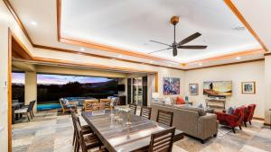 a dining room and living room with a ceiling fan at Wai'ula'ula 334 at Mauna Kea in Hapuna Beach