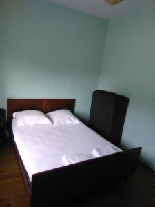 a bedroom with a bed with a laptop on it at Maison de vacances à Miramont-de-Guyenne in Miramont-de-Guyenne