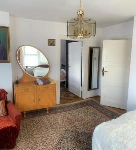 a bedroom with a mirror and a dresser and a bed at Domek nad morzem in Sopot
