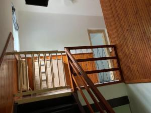 a staircase with wood and glass doors in a room at Chata na lúke in Tatranska Strba