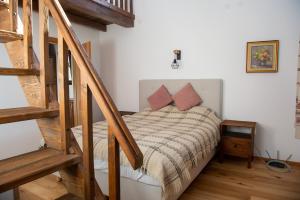 a bedroom with a bed and a stair case at Walnut Cottage 1 in Deredzhik-Kʼoy