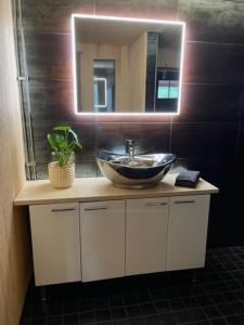 a bathroom with a sink and a mirror at Villa Sahi in Iisalmi +56 photos