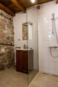 a bathroom with a glass shower and a sink at Walnut Cottage 1 in Deredzhik-Kʼoy