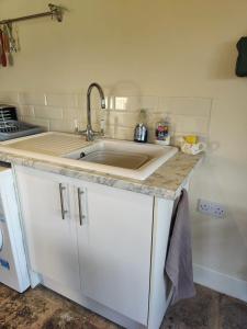 a kitchen with a sink and a counter top at The Dairy in Pershore