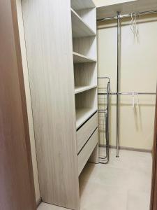 a walk in closet with a wooden door at Апартаменты «Одесские традиции» in Odesa