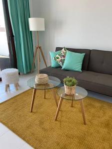 a living room with two tables and a couch at CASA MESANA Nuevo cama King size en playa con AIRE ACONDICIONADO in Playa Honda