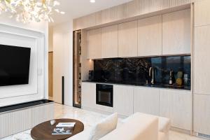 a living room with a white couch and a tv at Best Apartment SPA in Rzeszów