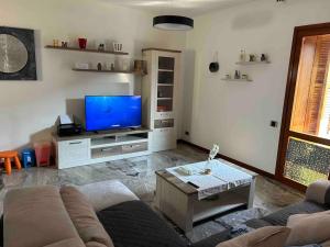 a living room with a couch and a flat screen tv at holy home in Mestre