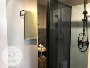 a bathroom with a shower with a glass door at Appartement Sealight in De Haan +19 photos