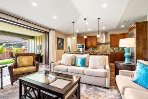 a living room with a couch and a table at Holua Kai 37 in Kailua-Kona