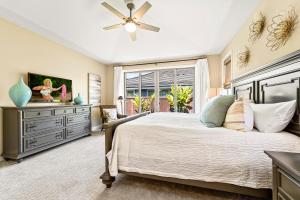 a bedroom with a large bed and a window at Holua Kai 37 in Kailua-Kona +28 photos