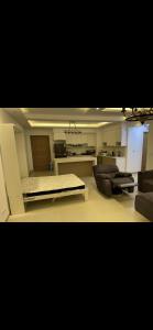 a large living room with a couch and a kitchen at marassi chalet in El Alamein