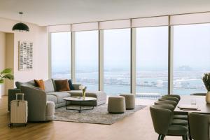 a living room with a couch and chairs and windows at Sonder at JBR The Walk in Dubai