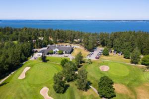 an aerial view of a golf course with the lake at Hotell Aqva Restaurang & Bar Ett Biosfärhotell med fokus på hållbarhet in Mariestad