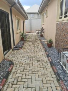 a brick walkway in front of a house at Chic 4 Bed bungalow Oluyole Akala express Ibadan in Ibadan