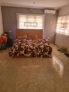 a bedroom with a bed with a cow blanket at Chic 4 Bed bungalow Oluyole Akala express Ibadan in Ibadan