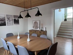 a dining room with a wooden table and chairs at Akureyri apartments in Akureyri