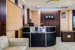 a lobby with a desk and a chair in a room at OYO Flagship Bridge View Hotel in Kānpur