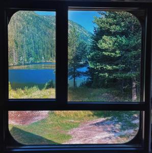 a view of a lake from a window at Zminica Lake House in Žabljak