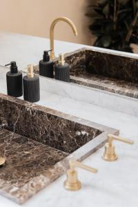 a kitchen counter with a sink and brass faucet at Palazzo Mazzini in Como