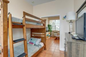 a bedroom with bunk beds and a living room at Indian Rocks Vacation Rental Condo Steps to Beach in Clearwater Beach
