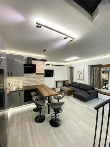 a kitchen and living room with a table and chairs at Brand New Luxury Apartment in Absolute Downtown in Budapest