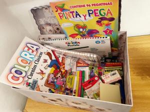 uma caixa de brinquedos para crianças e livros sobre uma mesa em Casa ' A ca Paca ' em Lanjarón