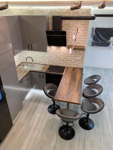 cocina con mesa de madera y taburetes en Brand New Luxury Apartment in Absolute Downtown en Budapest