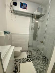 a bathroom with a shower and a toilet at Brand New Luxury Apartment in Absolute Downtown in Budapest