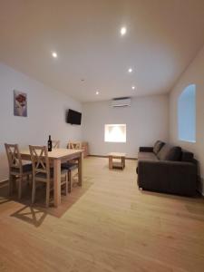 a living room with a table and a couch at Flower in Poljica
