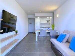 a living room with a couch and a table at Rentalmar Blue Beach Apartments & Pool in Salou