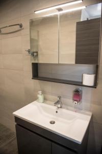 a bathroom with a white sink and a mirror at StayZeta in Análipsis