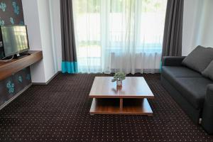 a living room with a couch and a coffee table at Lara Five in Hajdúszoboszló