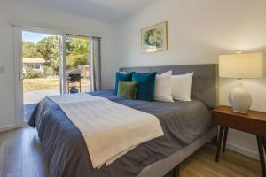 a bedroom with a large bed with blue and white pillows at Inviting Home with Patio Walk to Downtown Novato! in Novato